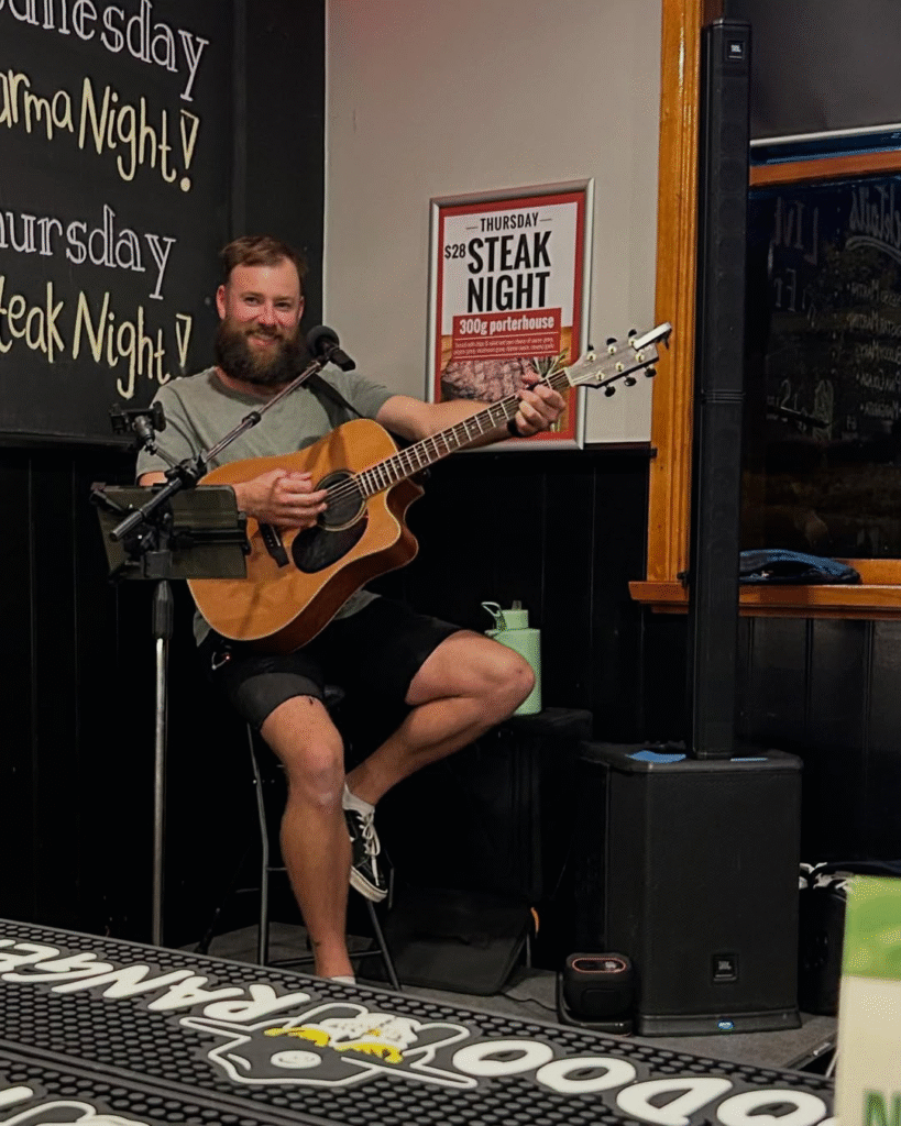 Musician Troy Elliot performing live with acoustic guitar at The Courthouse Hotel Smythesdale.
