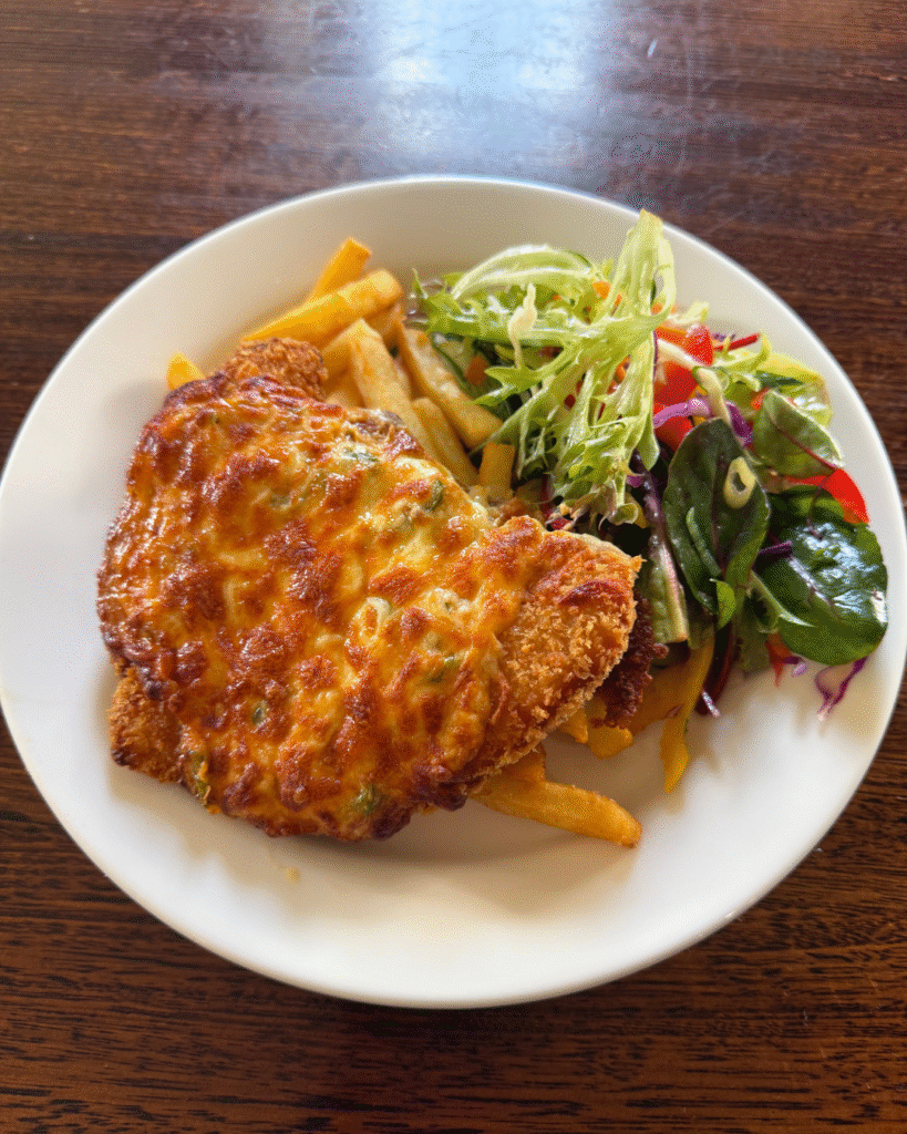 Chicken Parma with chips, salad, and a pot at The Courthouse Hotel Smythesdale